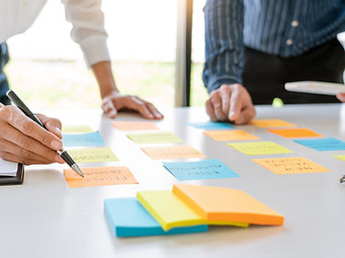 young business workers posting with sticky notes stickers reminders creative brainstormin