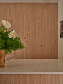 Leafy floral arrangement on top of a closet island in a walk in closet