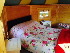 inside Swattesfield Pixie Hut with a bed made up