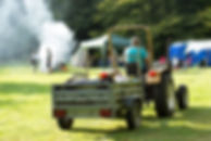 a tractor delivering campers their camping equipment