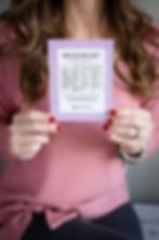 "Baby Sleep Cheat Sheet" against a patterned purple magnet that has information pertaining to wake windows, naps and total sleep needs for a baby