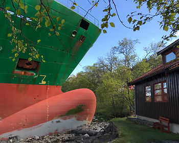 Bow of a cargo ship that has ploughed into a garden in front of a house in Norway