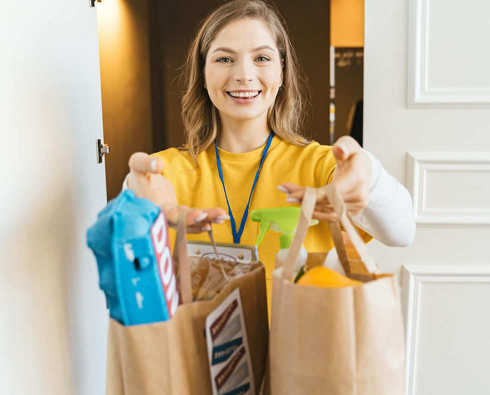 Kind young woman delivering groceries to an elderly friend