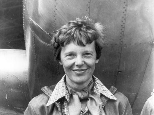 Earhart standing under the nose of her Lockheed