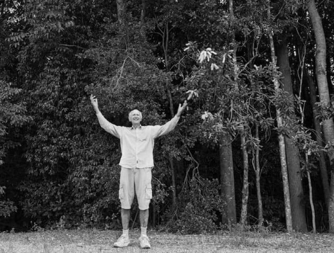 Tony Parkes standing in front of some the trees he has planted
