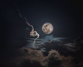 Moon shining between clouds