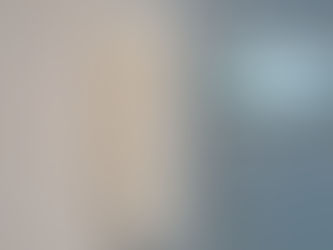 White paint being applied to a wall with a roller