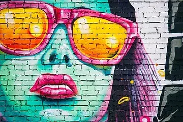Mural depicting a girl's face wearing sunglasses