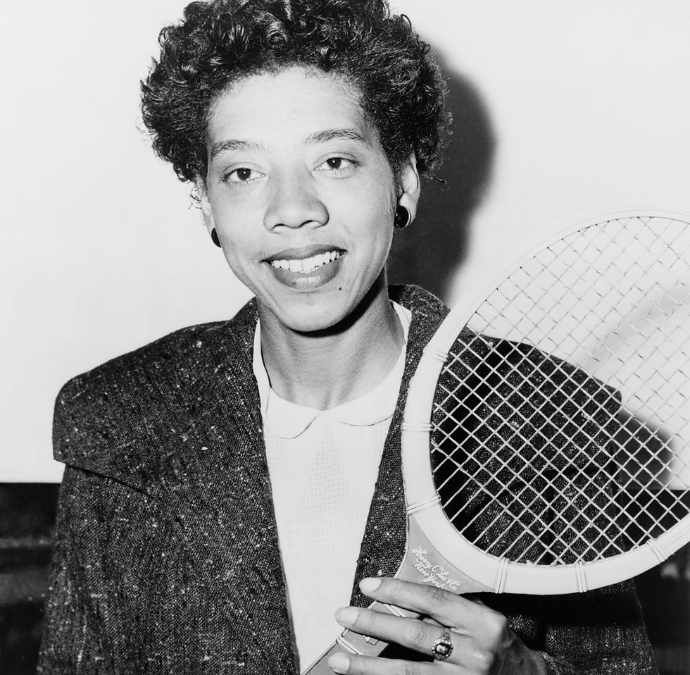 Althea Gibson posing with a tennis racket in 1957