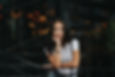 Young woman in a white T-shirt leaning on a railing