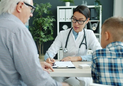 Female doctor writing medical notes at her desk