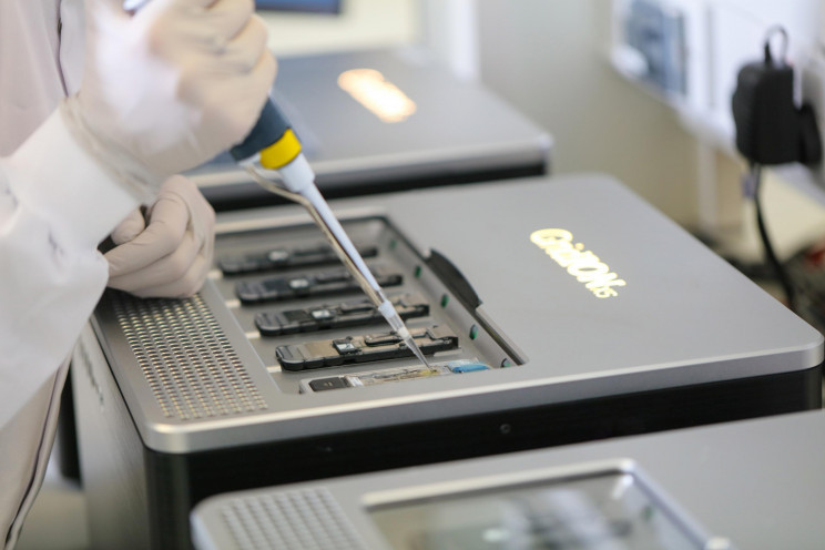 Scientist injecting DNA into a special machine