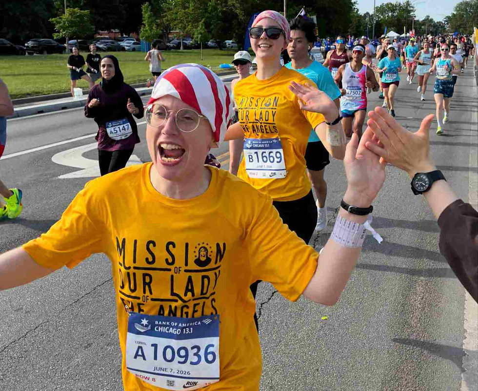 Sister Baliga high-fives a supporter at the Chicago Half Marathon last month