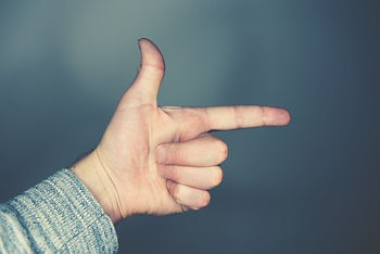 Hand making the shape of a finger gun
