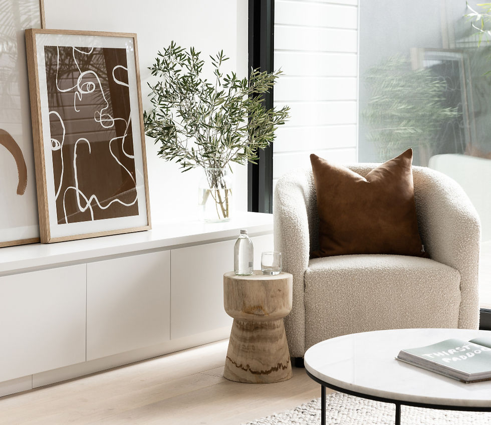 Cream coloured sofa next to a potted olive tree
