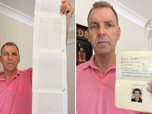 Laurence Watkins holding up his passport