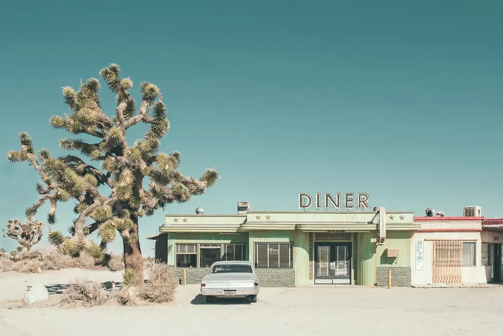 Roadside Art Deco diner in muted colours in the desert of the American West