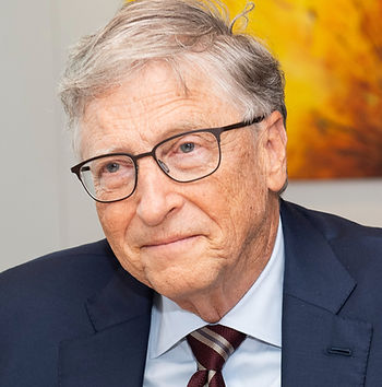 Bill Gates looking happily pensive in jacket and tie