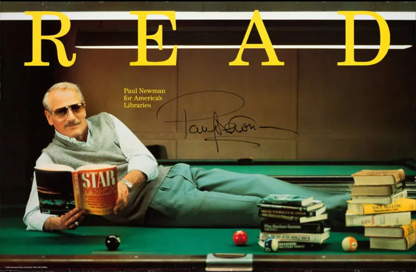 Paul Newman lounges on a pool table reading 'Star Warriors'