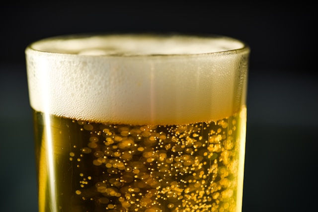 Glass of lager against a dark background