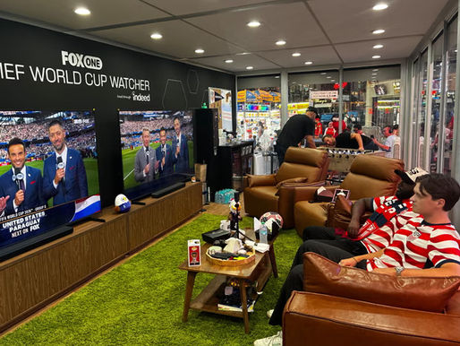 Austin Franklin (right) and Kevin Kotoko watch the World Cup while locked in a glass cube in Times Square, New York.