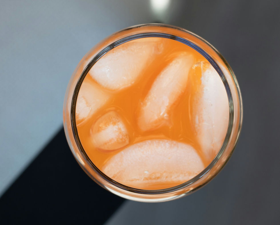 Orange coloured cocktail with lots of ice