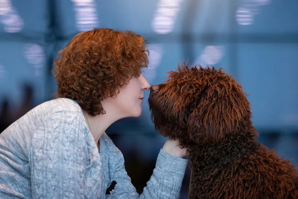 Woman with same hairstyle as her poodle