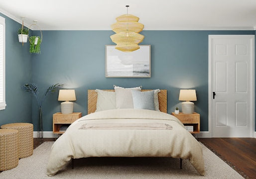 Bedroom painted in teal green, with dark wooden floorboards, and a white duvet.