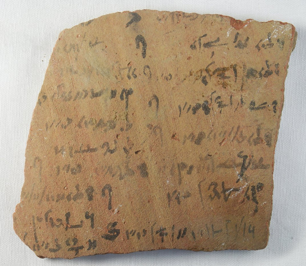 Small shard of Egyptian pottery with ink writing on it.