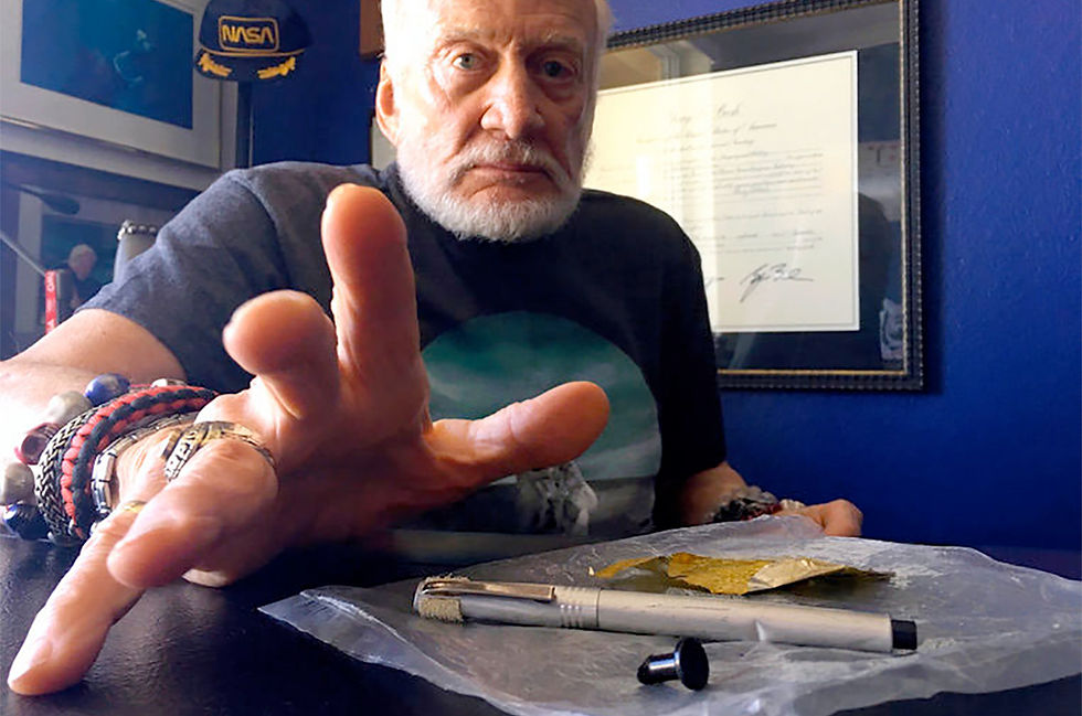 Buzz Aldrin with a dented silver plastic Duro Rocket pen