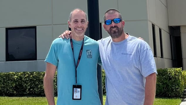 The pilot and air traffic controller hugging and smiling