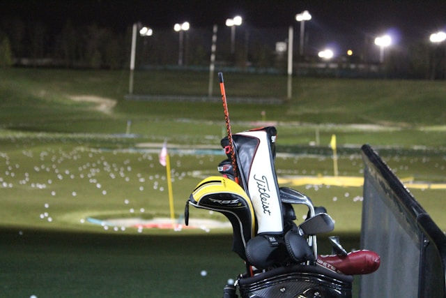 Set of golf clubs in a driving range booth