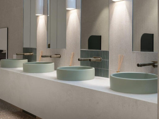 Series of contemporary hand washing basins in a hotel restroom