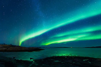 Three streaks of blue green stripes in the night sky