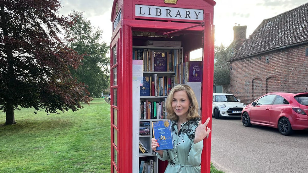 Sally Phillips outside a red phone box Pooh library