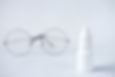 Small white vial containing eye drops