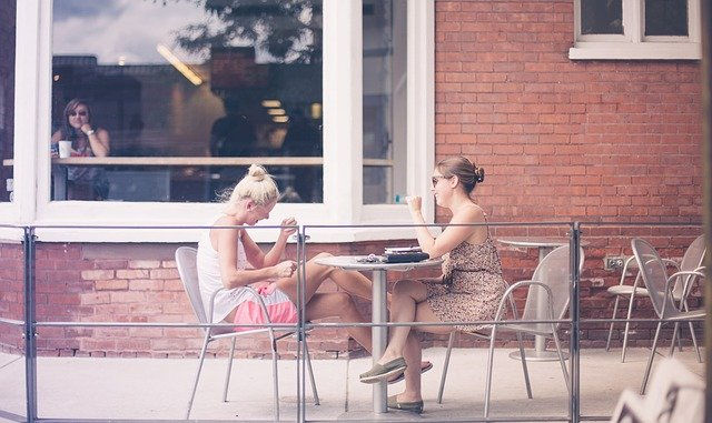 Two young women chatting in a cafe