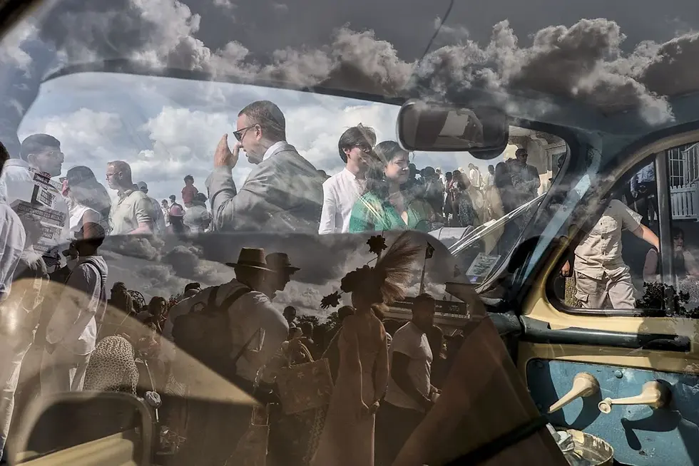 Crowd of people reflected in a car window