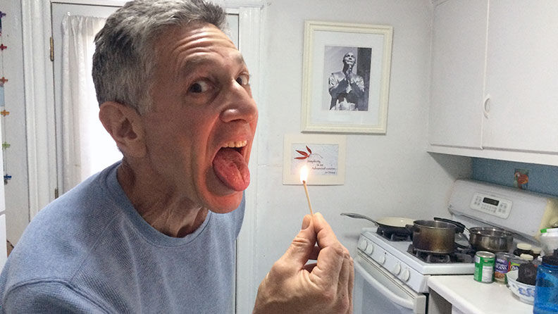 Ashrita Furman extinguishing a match in his mouth