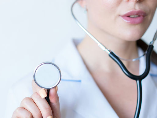 Female doctor wearing a white coat and a stethoscope