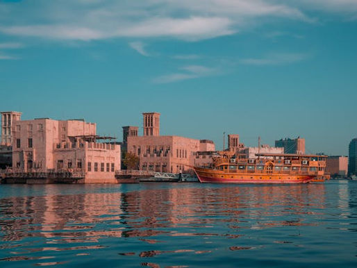 Traditional dhow by Dubai Creek at sunset