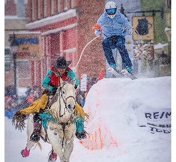 Cowboy on horse pulling a skier in Colorado