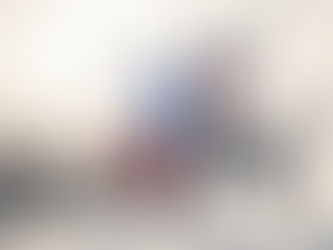 Two skiers traversing a mountain piste