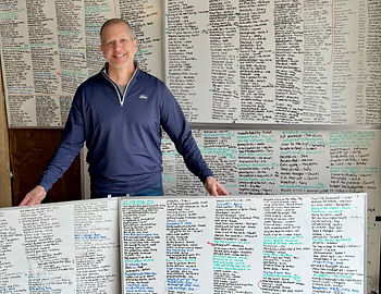 Mike O'Brien with half a dozen whiteboards covered in linguistic howlers