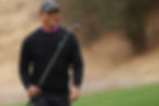 Tiger Woods walking down a fairway