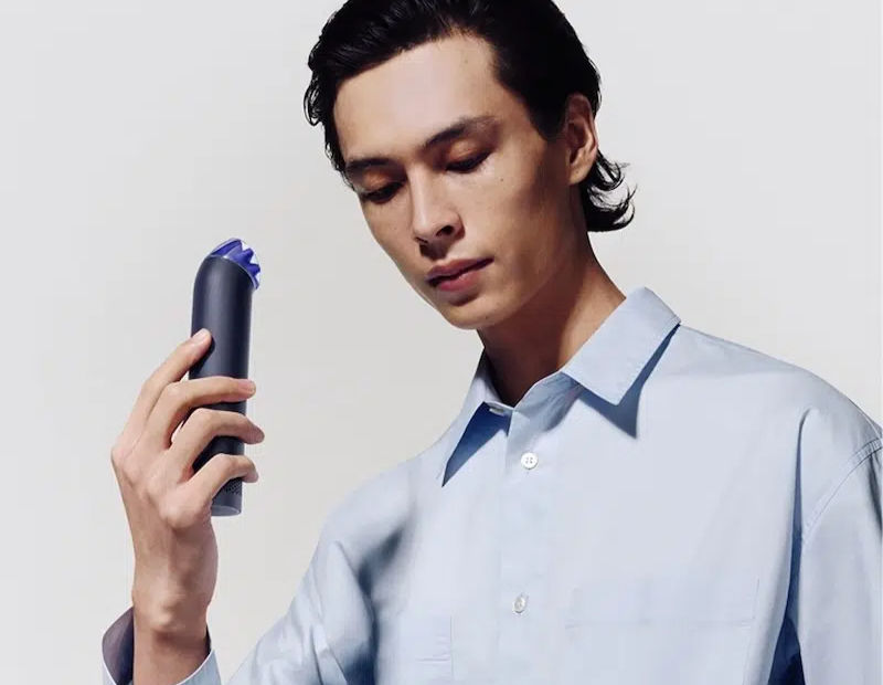 Young man holding a HushJet™ Mini Cool near his face