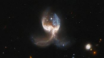 Two galaxies merging in deep space