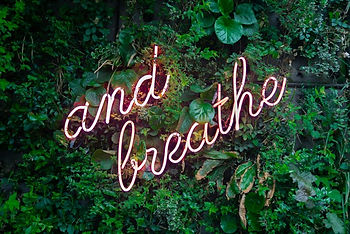 Neon sign saying: and breathe