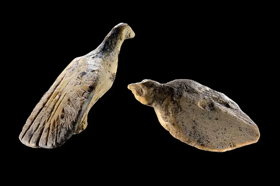 two tiny bird sculptures carved from mammoth tusk