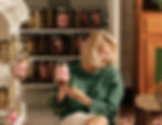 Pamela Anderson holding a jar of 'Pamela's Pickles'